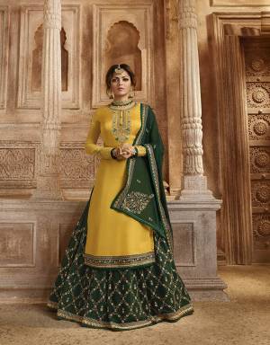 Celebrate This Festive And Wedding Season with Beauty And Comfort Wearing This Designer Indo-Western Suit In Yellow Colored Top And Bottom Paired With Contrasting Dark Green Colored Bottom And Dupatta. Its Pretty Embroidered Top IS Satin Georgette Based Paired With Santoon Bottom And Georgette Fabricated Lehenga And Dupatta. 