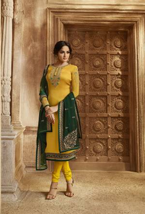 Celebrate This Festive And Wedding Season with Beauty And Comfort Wearing This Designer Indo-Western Suit In Yellow Colored Top And Bottom Paired With Contrasting Dark Green Colored Bottom And Dupatta. Its Pretty Embroidered Top IS Satin Georgette Based Paired With Santoon Bottom And Georgette Fabricated Lehenga And Dupatta. 