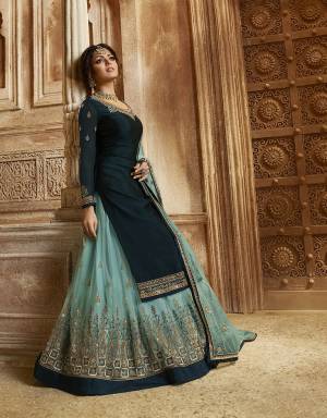 Go With The Pretty Shades Of Blue With This Designer Two In One Indo-Western Suit. Its Top And Bottom Are In Dark Teal Blue Color Paired With Sky Blue Colored Lehenga And Dupatta.  Its Top Is Fabricated On Satin Georgette Paired With Santoon Bottom And Net Fabricated Embroidered Lehenga And Dupatta. Buy Now.
