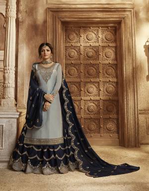 Look Pretty In This Lovely Designer Piece Which You can Wear In Two Ways As It Comes With A Bottom And Lehenga. Its Top And Bottom Are In Steel Blue Color Paired With Navy Blue Colored Lehenga And Dupatta. Its Top Is Fabricated On Satin Georgette Paired With Santoon Bottom And Georgette Fabricated Lehenga And Dupatta. Buy This Semi-Stitched Suit Now.
