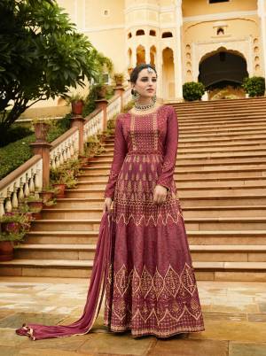 Catch All The Limelight Wearing This Designer Floor Length Suit In All Over Dark Pink Color. Its Top Is Fabricated On Art Silk Paired With Santoon Bottom And Chiffon Fabricated Dupatta. It Is Beautified With Tone To Tone Thread Work And Attractive Jari Work. 