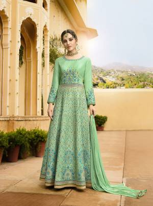 Celebrate This Festive Season With Beauty And Comfort Wearing This Designer Floor Length Suit In Sea Green Color Paired With Sea Green Colored Bottom And Dupatta. Its Heavy Embroidered Top Is Fabricated On Art Silk Paired With Santoon Bottom And Chiffon Fabricated Dupatta. 