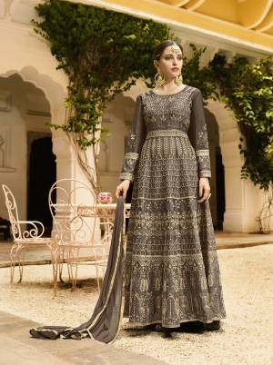 You Will Definitely Earn Lots Of Compliments In This Rich Color Shade With This Designer Floor Length Suit In All Over Dark Grey Color. Its Heavy Embroidered Top Is Fabricated On Art Silk Paired With Santoon Bottom And Chiffon Fabricated Dupatta. Buy Now.