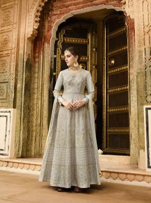 Flaunt Your Rich And Elegant Taste Wearing This Designer Floor Length Suit In Light Grey Color Paired With Light Grey Colored Bottom And Dupatta. Its Top Is Fabricated On Art Silk Beautified With Heavy Embroidery Paired With Santoon Fabricated Bottom And Chiffon Dupatta. Buy This Semi-Stitched Suit Now.