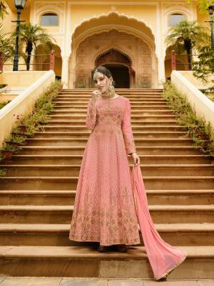 A Must Have Shade In Every Womens Wardrobe Is Here With This Designer Floor Length Suit In Dark Peach Color Paired With Dark Peach Colored Bottom And Dupatta. Its Top Is Fabricated On Art Silk Beautified With Heavy Work Paired With Santoon Bottom And Chiffon Fabricated Dupatta. Buy Now.