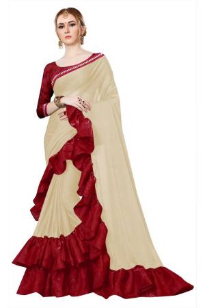 Simple And Elegant Looking Designer Saree Is Here In Cream Color Paired With Maroon Colored Blouse. This Saree Is Fabricated On Lycra Beautified With Ruffles And Lace Border, Paired With Satin Silk Fabricated Blouse 