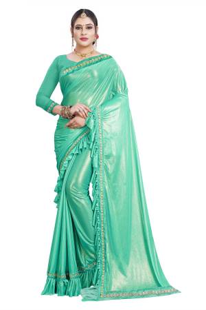 Celebrate This Festive Seaoson With Beauty And Comfort Wearing This Designer Lycra Based Saree In Sea Green Color Paired With Sea Green Colored Blouse. This Saree Has Pretty Ruffles And Lace Border Which Is Trend. Buy This Designer Saree Now.