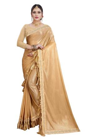 Catch All The Limelight Wearing This Designer Saree In Golden Color Paired With Golden Colored Blouse. This Saree Is Fabricated On Lycra Paired With Satin Silk Fabricated Blouse. This Pretty Ruffle Border Saree Is Light In Weight And Easy To Carry All Day Long. 