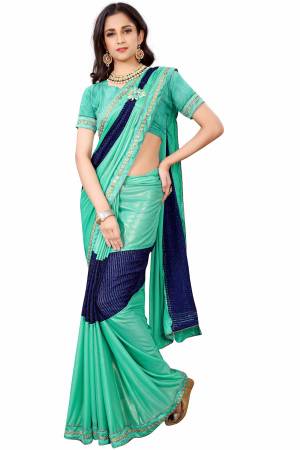 Add This Beatiful Designer Saree To Your Wardrobe For The Upcoming Festive Season. Grab This Lycra Based Designer Saree In Sea Green Colored Paired With Sea Green Colored Blouse. This Saree Has Pretty Lace Border With Patch Work. 
