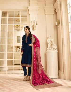 Enhance Your Personality Wearing This Designer Straight Suit In Navy Blue Color Paired With Contrasting Dark Pink Colored Dupatta. Its Pretty Embroidered Top Is Fabricated On Satin Georgette Paired With Santoon Bottom And Jacquard Silk Fabricated Dupatta. 