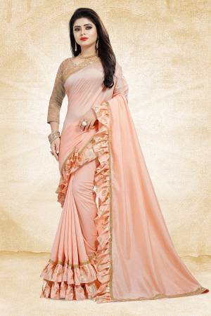 Get Ready For The Upcoming Party And Festives With This Designer Saree In Peach Color Paired With Peach Colored Blouse. This Saree Is Fabricated On Vichitra Silk Paired With Jacquard Silk Fabricated Blouse. It Has Very Attractive Foil Printed Frill And Lace Borders. Buy Now.