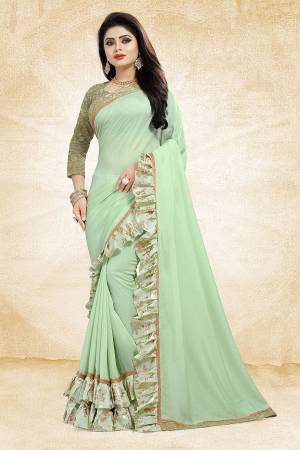 Get Ready For The Upcoming Party And Festives With This Designer Saree In Pastel Green Color Paired With Pastel Green Colored Blouse. This Saree Is Fabricated On Vichitra Silk Paired With Jacquard Silk Fabricated Blouse. It Has Very Attractive Foil Printed Frill And Lace Borders. Buy Now.