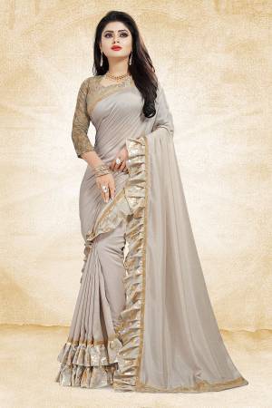 Get Ready For The Upcoming Party And Festives With This Designer Saree In Grey Color Paired With Grey Colored Blouse. This Saree Is Fabricated On Vichitra Silk Paired With Jacquard Silk Fabricated Blouse. It Has Very Attractive Foil Printed Frill And Lace Borders. Buy Now.