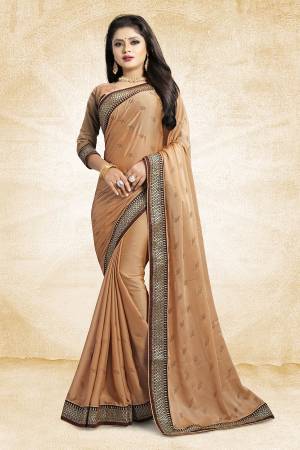 Flaunt Your Rich And Elegant Taste Wearing This Designer Saree In Beige Color Paired With Beige Colored Blouse. This Saree Is Fabricated On Satin Georgette Paired With Art Silk Fabricated Blouse. It Is Beautified With Heavy Embroidered Lace Border And Stone Work Butti Pattern Over The Saree. 