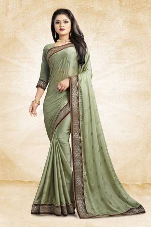 Flaunt Your Rich And Elegant Taste Wearing This Designer Saree In Pastel Green Color Paired With Pastel Green Colored Blouse. This Saree Is Fabricated On Satin Georgette Paired With Art Silk Fabricated Blouse. It Is Beautified With Heavy Embroidered Lace Border And Stone Work Butti Pattern Over The Saree. 