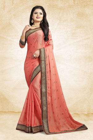Flaunt Your Rich And Elegant Taste Wearing This Designer Saree In Peach Color Paired With Peach Colored Blouse. This Saree Is Fabricated On Satin Georgette Paired With Art Silk Fabricated Blouse. It Is Beautified With Heavy Embroidered Lace Border And Stone Work Butti Pattern Over The Saree. 
