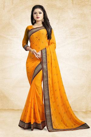Flaunt Your Rich And Elegant Taste Wearing This Designer Saree In Musturd Yellow Color Paired With Musturd Yellow Colored Blouse. This Saree Is Fabricated On Satin Georgette Paired With Art Silk Fabricated Blouse. It Is Beautified With Heavy Embroidered Lace Border And Stone Work Butti Pattern Over The Saree. 