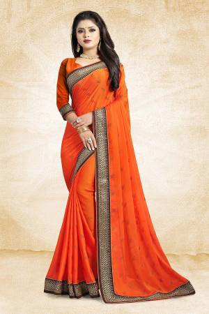 Celebrate This Festive Season With Beauty And As Well As Comfort At The Same Time With This Beautiful Designer Saree In Orange Color Paired With Orange Colored Blouse. This Saree Is Satin Georgette Based Paired With Art Silk Fabricated Blouse. It Has Heavy Embroidered Lace Border With Stone Work All Over The Saree. Buy This Designer Piece Now.