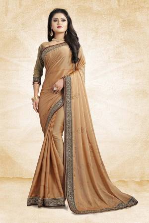Celebrate This Festive Season With Beauty And As Well As Comfort At The Same Time With This Beautiful Designer Saree In Beige Color Paired With Beige Colored Blouse. This Saree Is Satin Georgette Based Paired With Art Silk Fabricated Blouse. It Has Heavy Embroidered Lace Border With Stone Work All Over The Saree. Buy This Designer Piece Now.