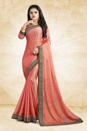 Celebrate This Festive Season With Beauty And As Well As Comfort At The Same Time With This Beautiful Designer Saree In Peach Color Paired With Peach Colored Blouse. This Saree Is Satin Georgette Based Paired With Art Silk Fabricated Blouse. It Has Heavy Embroidered Lace Border With Stone Work All Over The Saree. Buy This Designer Piece Now.