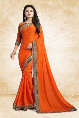 Celebrate This Festive Season With Beauty And As Well As Comfort At The Same Time With This Beautiful Designer Saree In Orange Color Paired With Orange Colored Blouse. This Saree Is Satin Georgette Based Paired With Art Silk Fabricated Blouse. It Has Heavy Embroidered Lace Border With Stone Work All Over The Saree. Buy This Designer Piece Now.