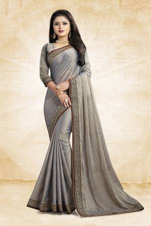 Celebrate This Festive Season With Beauty And As Well As Comfort At The Same Time With This Beautiful Designer Saree In Grey Color Paired With Grey Colored Blouse. This Saree Is Satin Georgette Based Paired With Art Silk Fabricated Blouse. It Has Heavy Embroidered Lace Border With Stone Work All Over The Saree. Buy This Designer Piece Now.
