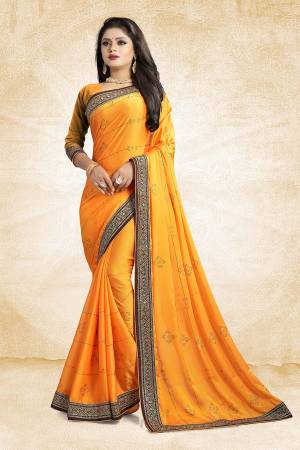 Celebrate This Festive Season With Beauty And As Well As Comfort At The Same Time With This Beautiful Designer Saree In Musturd Yellow Color Paired With Musturd Yellow Colored Blouse. This Saree Is Satin Georgette Based Paired With Art Silk Fabricated Blouse. It Has Heavy Embroidered Lace Border With Stone Work All Over The Saree. Buy This Designer Piece Now.