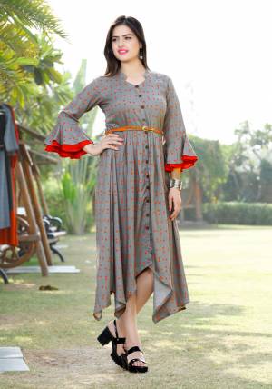 Here Is Another Readymade Kurti With High Low Pattern In Grey Color. This Kurti Is Fabricated On Rayon Beautified With Polka Dots Prints All Over It With Contrasting Red Color. 