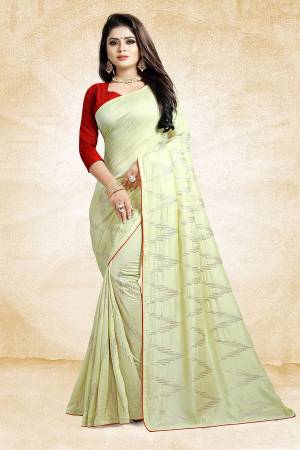 Look Pretty In This Rich And Elegant Looking Designer Saree In Pale Yellow Color Paired With Contrasting Red Colored Blouse. This Saree And Blouse Are Silk Based Beautified With Attractive Embroidery. Also It Is Light In Weight And Easy To Carry All Day Long. 