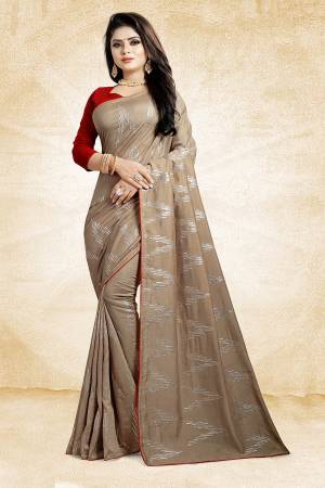 Look Pretty In This Rich And Elegant Looking Designer Saree In Light Brown Color Paired With Contrasting Red Colored Blouse. This Saree And Blouse Are Silk Based Beautified With Attractive Embroidery. Also It Is Light In Weight And Easy To Carry All Day Long. 