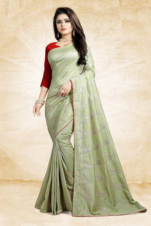 Look Pretty In This Rich And Elegant Looking Designer Saree In Pastel Green Color Paired With Contrasting Red Colored Blouse. This Saree And Blouse Are Silk Based Beautified With Attractive Embroidery. Also It Is Light In Weight And Easy To Carry All Day Long. 