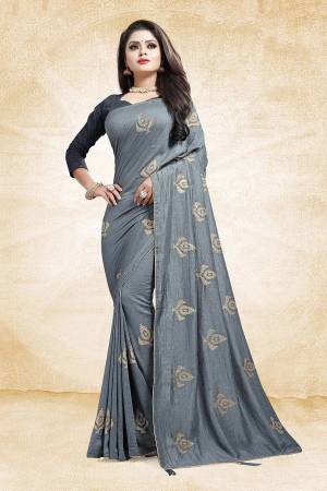 For A Bold And Beautiful Look This Festive Season, Grab This Designer Saree In Grey Color Paired With Dark Grey Colored Blouse. This Saree And Blouse Are Silk Based Beautified With Embroidered Butti All over The Saree. Buy This Saree Now.