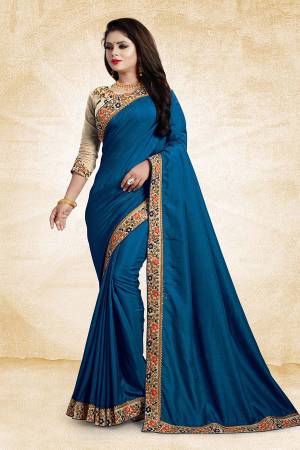 Here Is An Elegant And Royal Looking Designer Saree In Blue Color Paired With Beige Colored Blouse. This Saree And Blouse Are Silk Based Based Beautified With Contrasting Thread Work Over The Blouse And Saree Lace Border. 