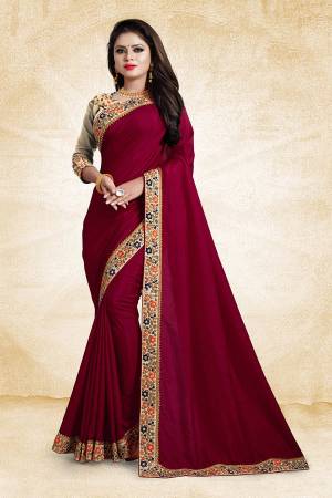Here Is An Elegant And Royal Looking Designer Saree In Dark Pink Color Paired With Beige Colored Blouse. This Saree And Blouse Are Silk Based Based Beautified With Contrasting Thread Work Over The Blouse And Saree Lace Border. 