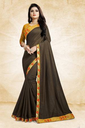 Celebrate The Festive Season With Beauty And Comfort Wearing This Designer Silk Based Saree In Dark Grey Color Paired With Contrasting Musturd Yellow Colored Blouse. It Is Beautified With Contrasting Thread And Jari Work Over The Blouse And Saree Lace Border. Buy This Designer Saree Now.