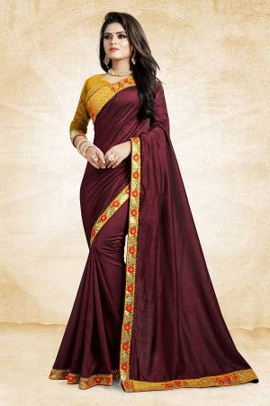 Celebrate The Festive Season With Beauty And Comfort Wearing This Designer Silk Based Saree In Maroon Color Paired With Contrasting Musturd Yellow Colored Blouse. It Is Beautified With Contrasting Thread And Jari Work Over The Blouse And Saree Lace Border. Buy This Designer Saree Now.