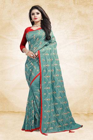 Get Ready For The Upcoming Wedding And Festive Season With This Heavy Embroidered Designer Saree In Sky Blue Color Paired With Contrasting Red Colored Blouse. This Saree And Blouse are Silk Based Beautified With Embroidery All Over The Saree.