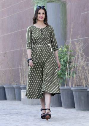 Another Formal and Rich Looking Readymade Kurti Is Here In Dark Olive Green Color Fabricated On Rayon. It IS Beautified With Lining Prints All Over It. Buy Now.