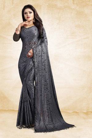 Flaunt Your Rich And Elegant Taste Wearing This Designer Saree In Grey Color Paired With Black Colored Blouse, This Saree And Blouse Are Fabricated On Fancy China Fabrics Which Is Light Weight And Easy To Carry Throughout The Gala.