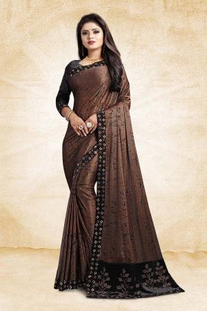 For A Bold And Beautiful Look, Grab This Designer Fancy China Fabricated Saree In Brown Color Paired With Black Colored Blouse. It Is Beautified With Prints And Lace Border, Buy This Designer Saree Now.