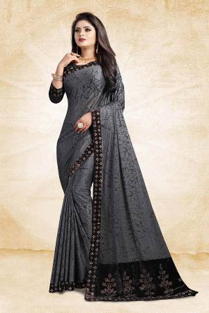 Flaunt Your Rich And Elegant Taste Wearing This Designer Saree In Grey Color Paired With Black Colored Blouse, This Saree And Blouse Are Fabricated On Fancy China Fabrics Which Is Light Weight And Easy To Carry Throughout The Gala.