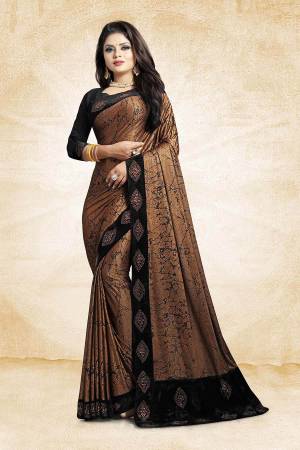 For A Bold And Beautiful Look, Grab This Designer Fancy China Fabricated Saree In Brown Color Paired With Black Colored Blouse. It Is Beautified With Prints And Lace Border, Buy This Designer Saree Now.