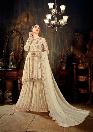 Rich And Elegant Looking Designer Sharara Suit Is Here In Beige Color Paired With Beige Colored Bottom And Dupatta. This Sharara All Over Suit In Georgette Based Beautified With Heavy Embroidery Giving A Rich And Subtle Look To Your Personality. 