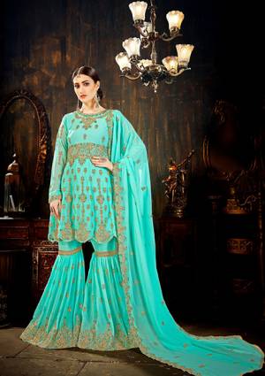 Catch All The Limelight At The Next Wedding You Attend Wearing This Designer Sharara Suit In Turquoise Blue Color. This Pretty Suit All Over Is Fabricated On Georgette Beautified With Attractive Embroidery. It Is Light In Weight And Easy To Carry Throughout The Gala.