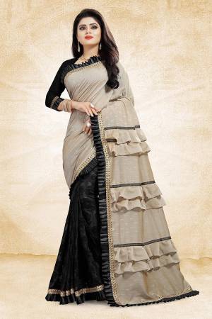 Get Ready With The Running Frill Pattern Trend With This Designer Saree In Beige And Black Color Paired With Black Colored Blouse. This Saree Is Fabricated On Fancy Fabrics Paired With Art Silk Fabricated Blouse. It Is Beautified With Frill And Lace Border. Buy Now.