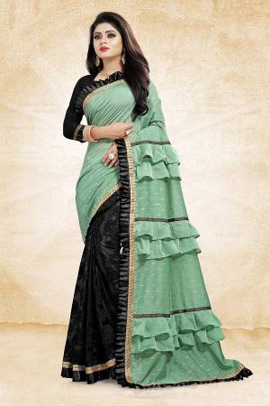 Get Ready With The Running Frill Pattern Trend With This Designer Saree In Sea Green And Black Color Paired With Black Colored Blouse. This Saree Is Fabricated On Fancy Fabrics Paired With Art Silk Fabricated Blouse. It Is Beautified With Frill And Lace Border. Buy Now.