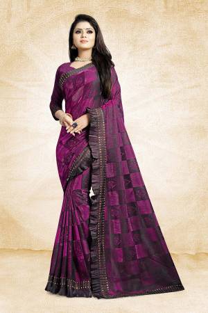 Catch All The Limelight Wearing This Designer Saree In Purple Color Paired With Purple Colored Blouse. This Saree Is Fancy Fabric Based Paired With Art Silk Fabricated Blouse. It Is Beautified With Frill And Stone Work Over The Saree Border. 