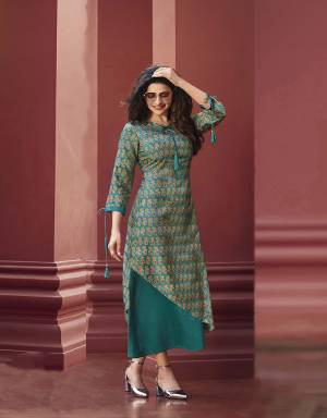 Here Is A Beautiful Asymetric Patterend Designer Readymade Kurti In Teal Blue Color Fabricated On Art Silk And Satin. It Is Beautified With Small Prints And Stone Work. This Pretty Kurti Is Available In all Sizes, Choose As Per Your Comfort. 