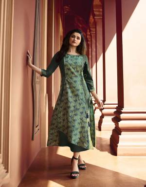 Go With The Shades Of Green With This Designer Readymade Kurti In Dark Green And Light Green Color Fabricated On Art Silk And Satin. It Is Beautified With Pretty Prints And Stone Work. 