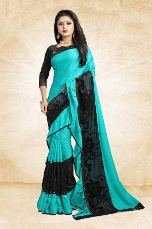 Adopt The Fashion Trend In Your Style With This Designer Frill Saree In Turquoise Blue And Black Color Paired With Black Colored Blouse, This Saree Is Fabricated On Soft Silk Paired With Art Silk Fabricated Blouse. It Is Beautified with Fancy Lace Border And Frill. Buy This Saree Now.
